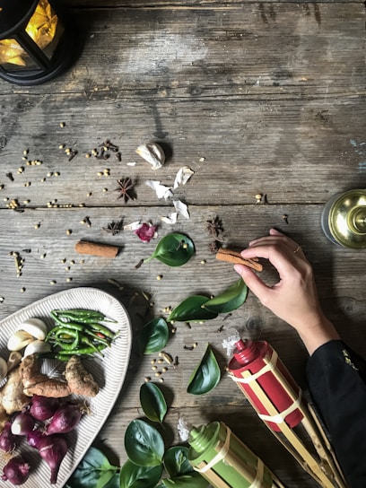 A vibrant display of traditional Cuban spices and herbs on rustic wooden table