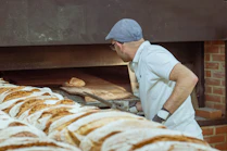 Industrial bakery bread production line with baked loaves