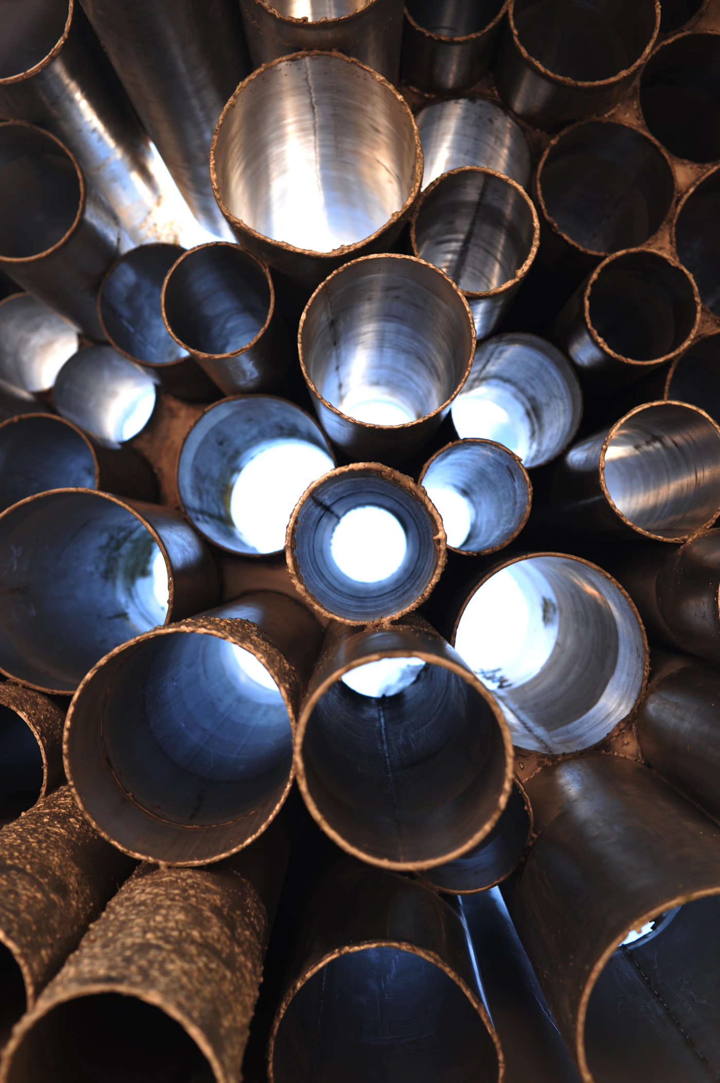 Polished hollow metal pipe ends showing circular openings