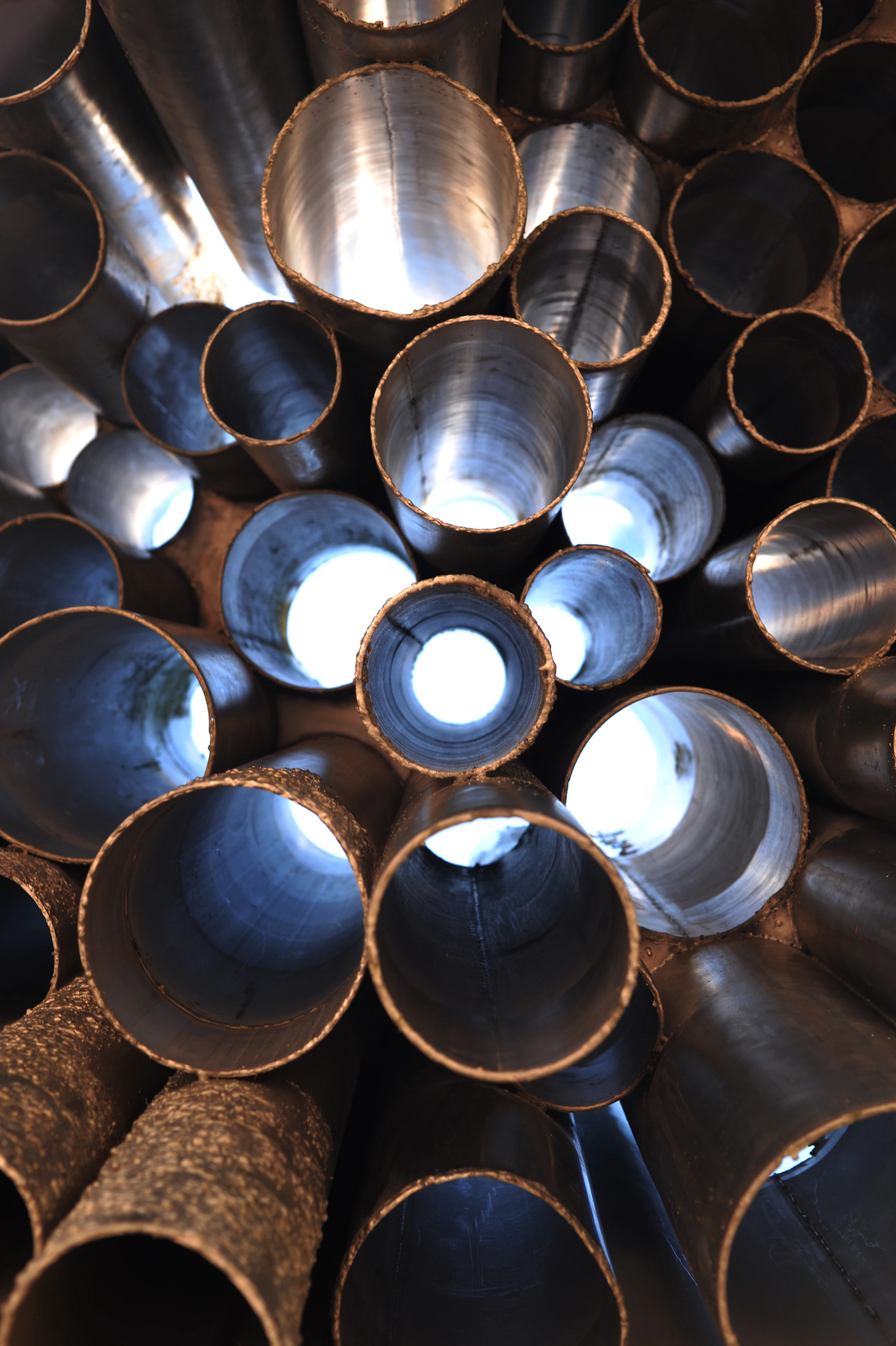 Bundle of smaller round metal pipes showing hollow circular openings