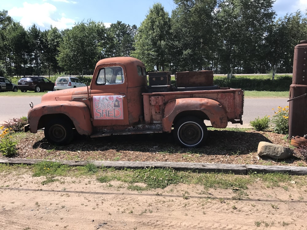 brown classic single cab pickup truck parked on roadside