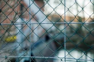Wide shot of the chainlink fence installation demonstrating its robust and precise construction.