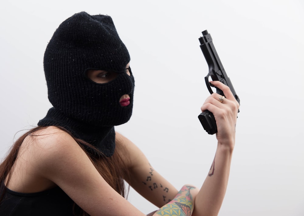 woman with bonnet and semi automatic handgun