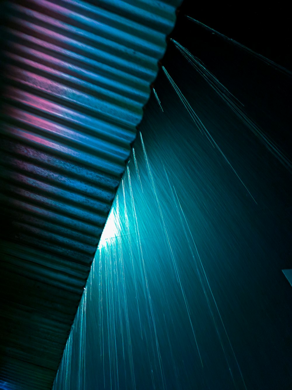 a close up of a metal roof with a blue sky in the background