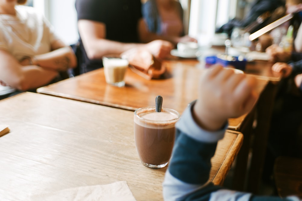 people sitting near brown wooden table