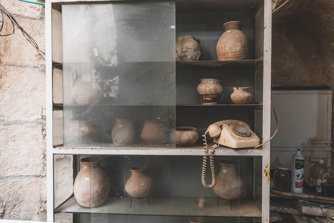 assorted pots on white metal display cabinet