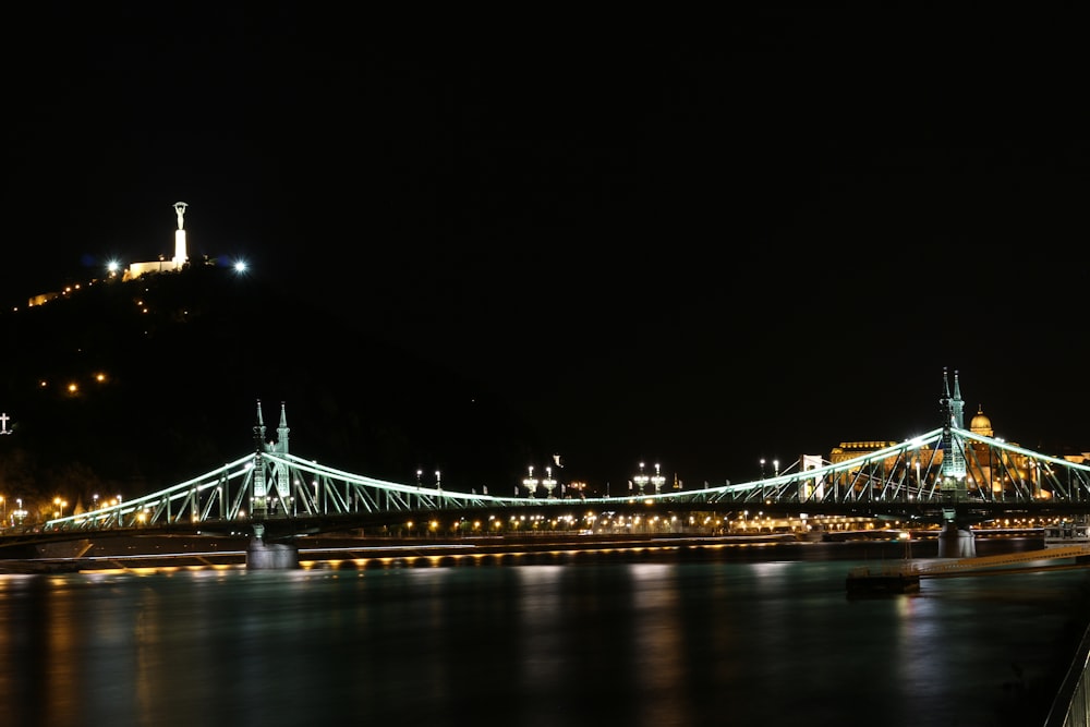 photo of lighted suspension bridge at night