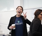 woman wearing suit making hand peace sign