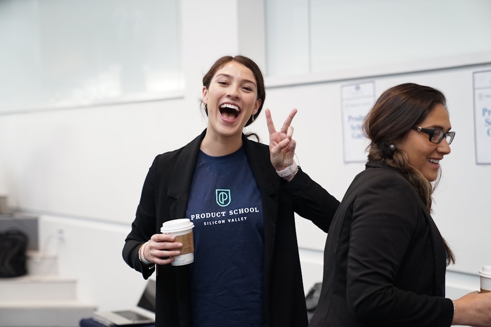 woman wearing suit making hand peace sign