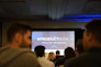 people in conference with projector screen in front