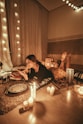 woman prawn lying on floor with lighted candles