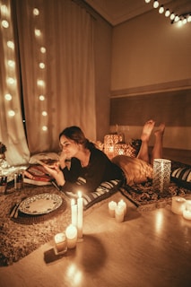 woman prawn lying on floor with lighted candles