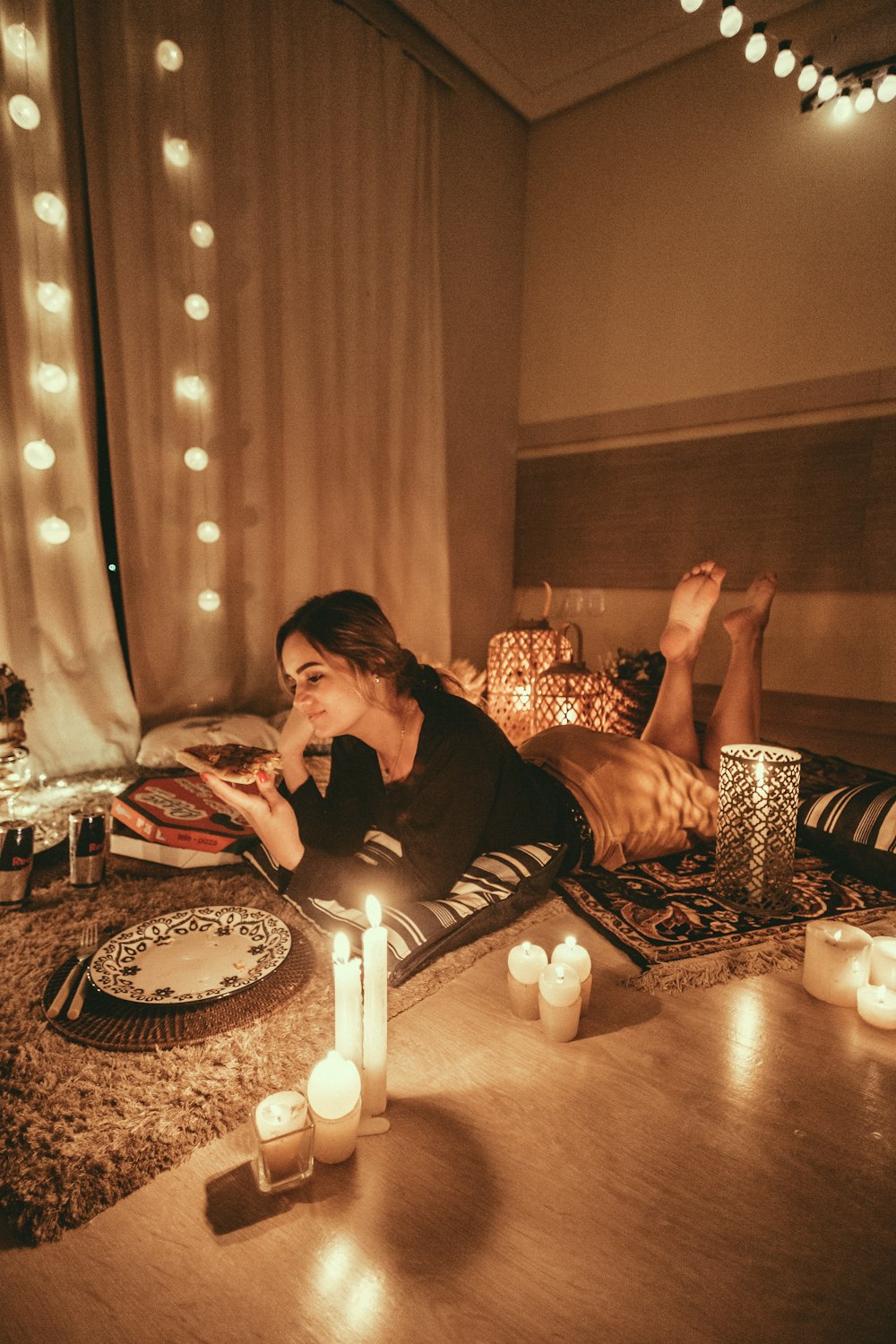 woman prawn lying on floor with lighted candles