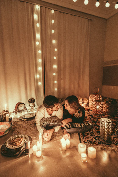 A cozy scene of a couple playing a digital game together on a tablet, surrounded by soft lighting and romantic decor.