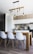 brown wooden dining table with white chairs near kitchen