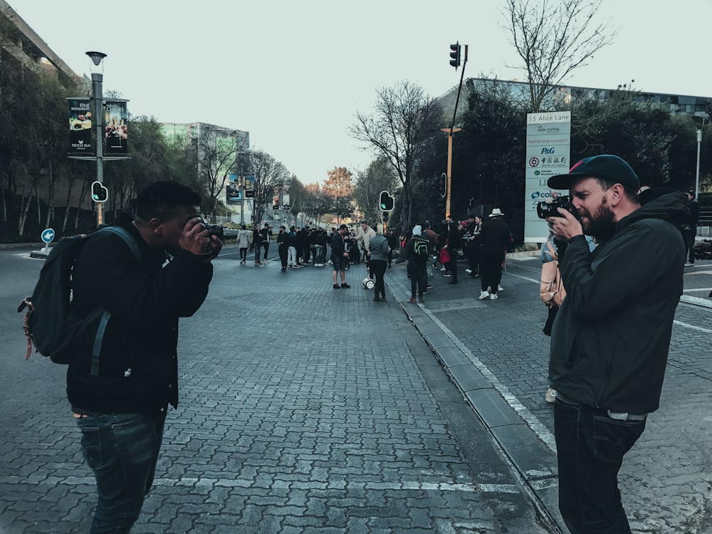 two men taking photo each other