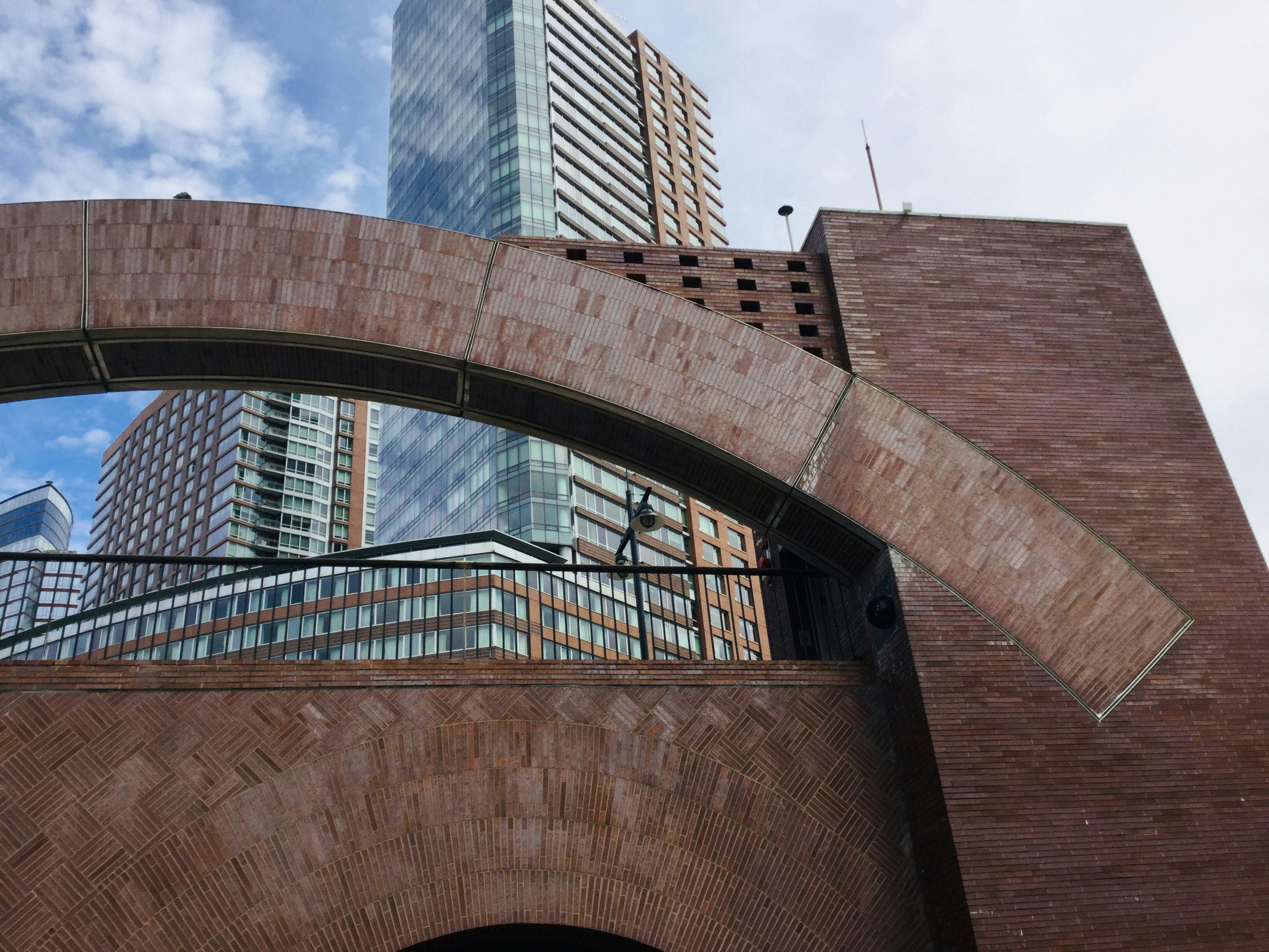 brown concrete tunnel near high-rise building
