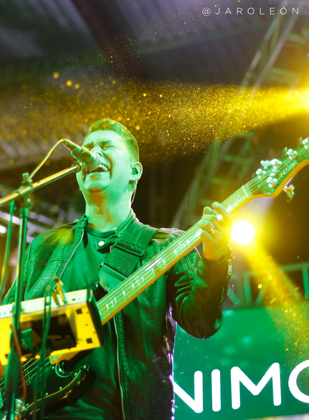 a man that is standing up with a guitar