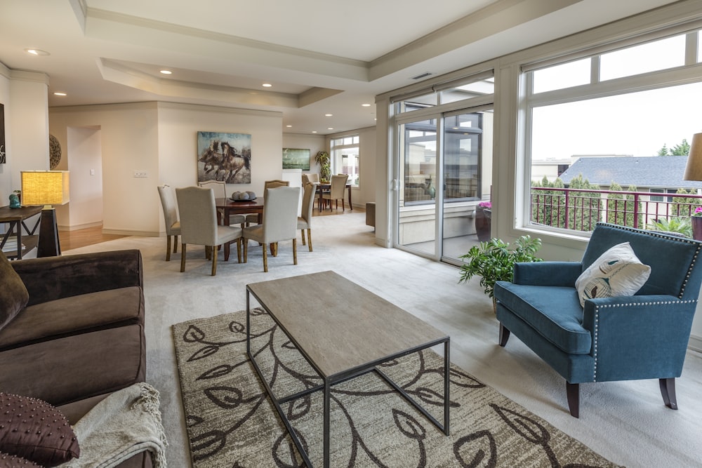 brown wooden coffee table and blue armchair