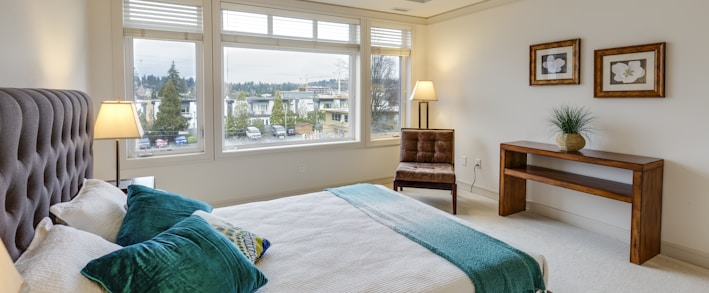 two green and white pillows on empty bed