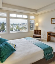 two green and white pillows on empty bed