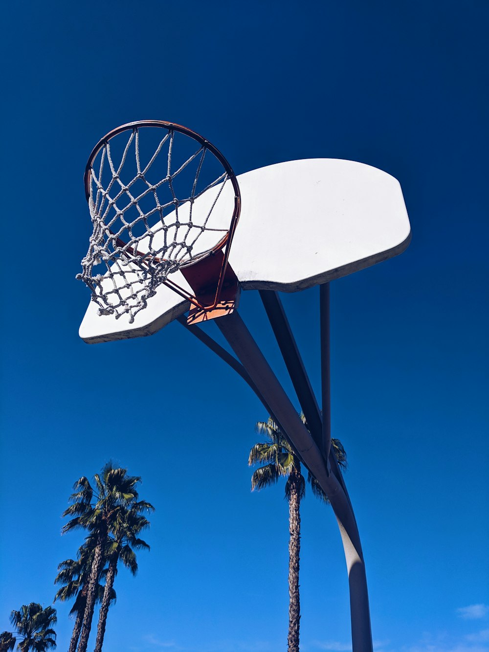 black and white basketball system across blue sky
