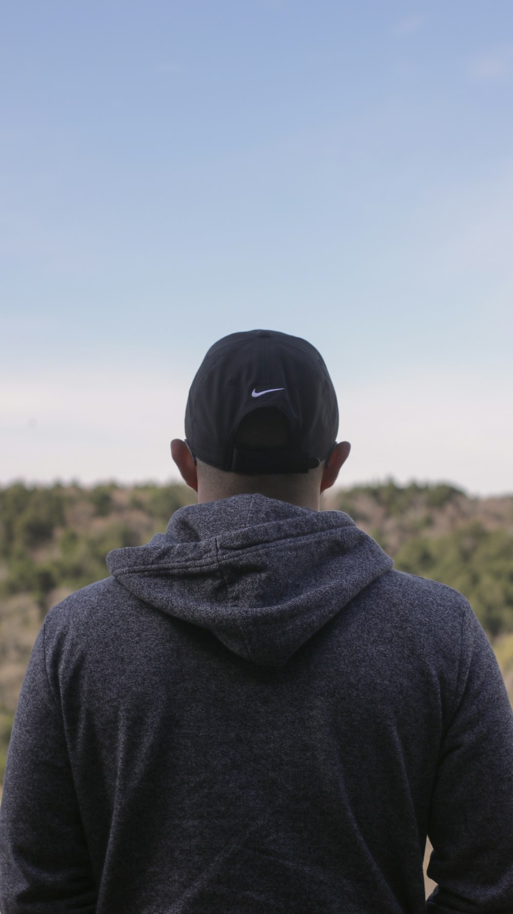 man wearing black hooded jacket