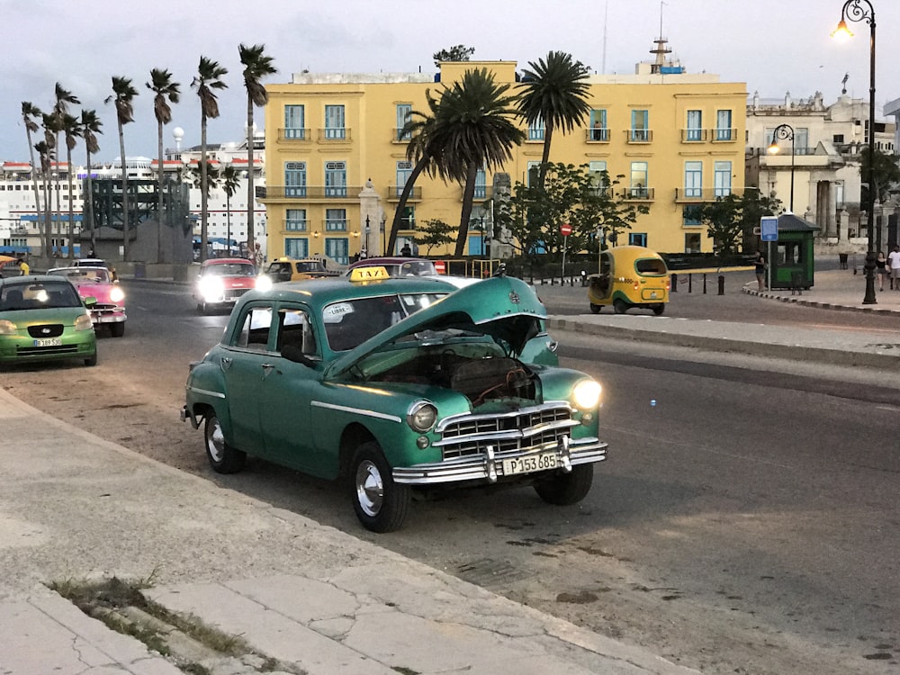 green sedan on road