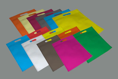 assorted-color handbags on gray surface