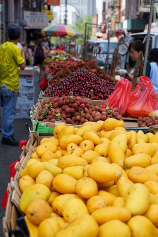 A vibrant market scene in Madagascar with fresh lychees and spices displayed.