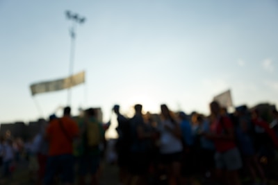 A blurry, black-and-white photo of a crowd holding awkwardly made signs with misspelled slogans.