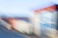 An abstract cityscape merging with swirling clouds, evoking a sense of mystery.