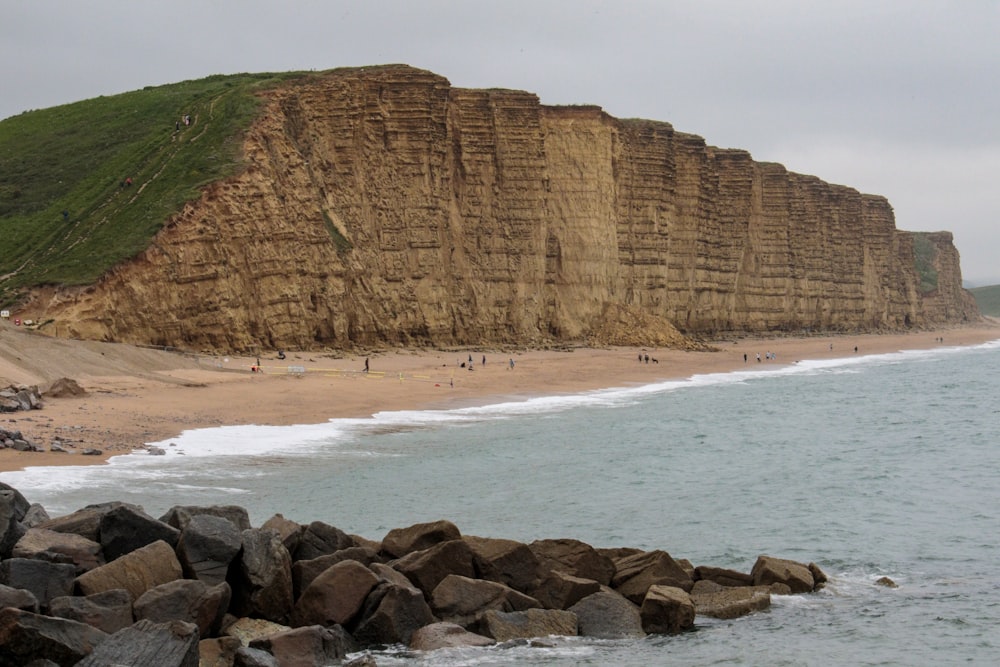 rock formation near body of water during daytime