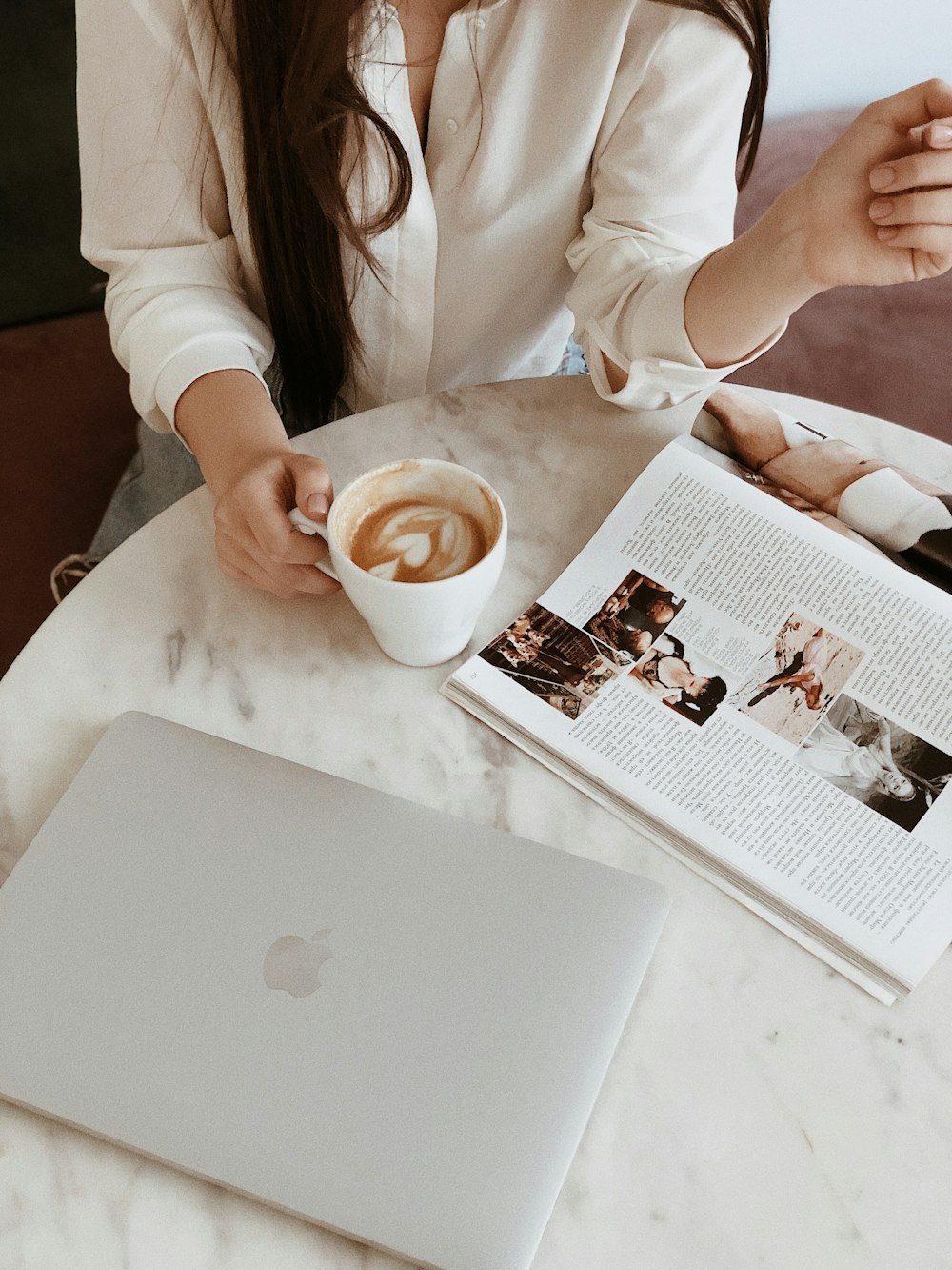 woman holding white ceramic mug with coffee