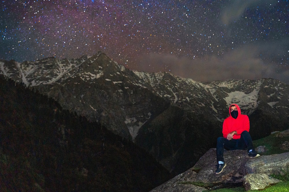 man sitting on rock