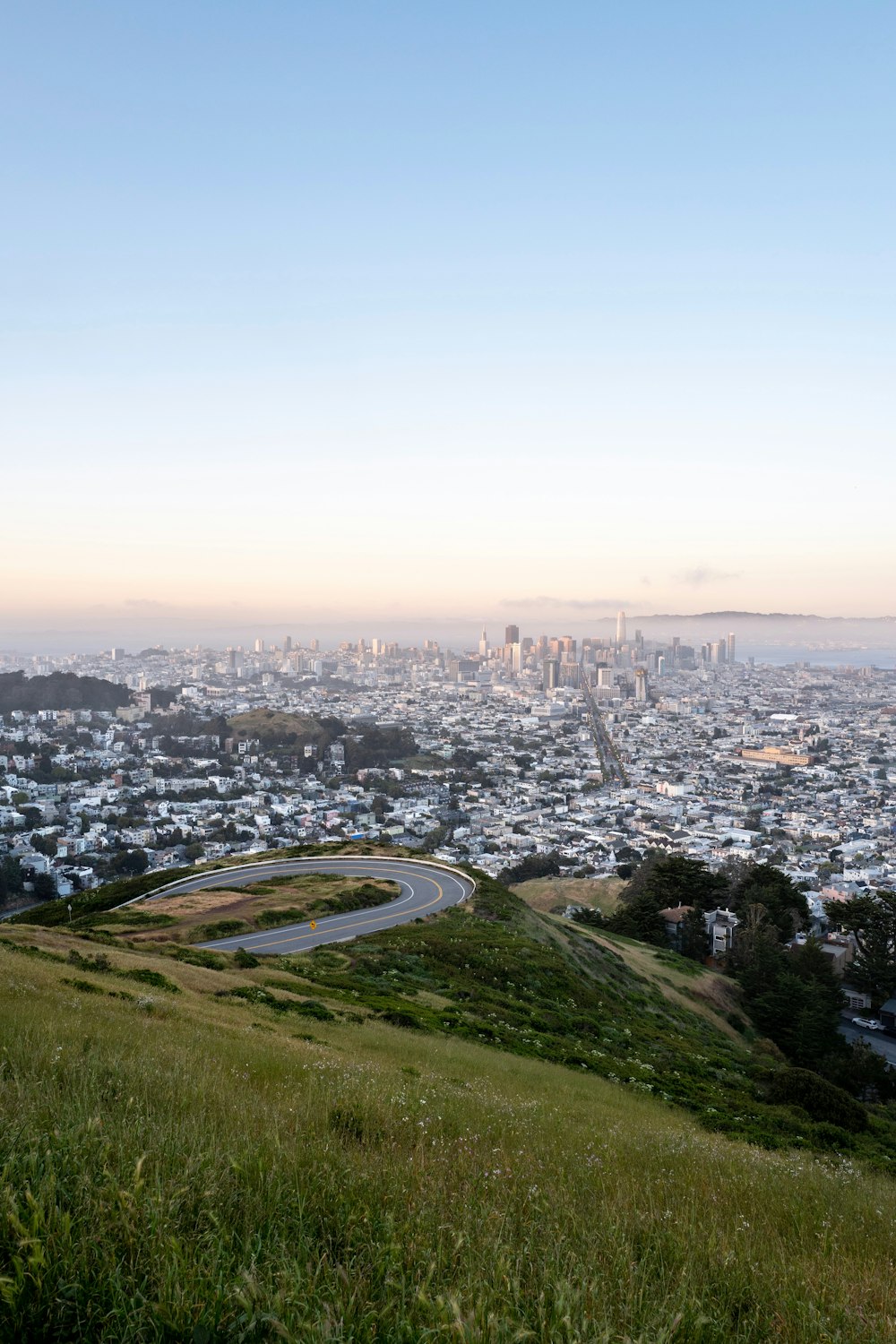 road, grass, and city during day