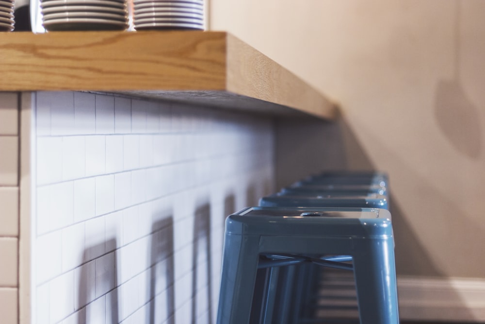 four blue plastic stools