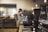 A barista skillfully preparing coffee in a cozy coffee shop setting.