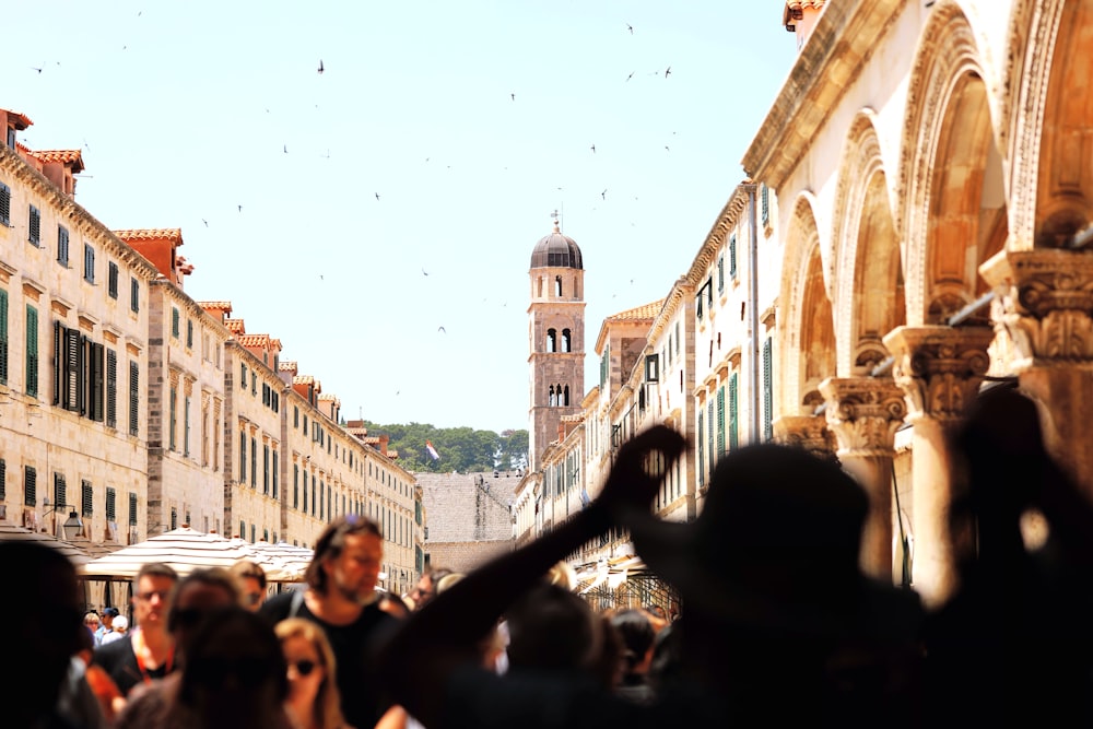 crowd at a market between brown buildings