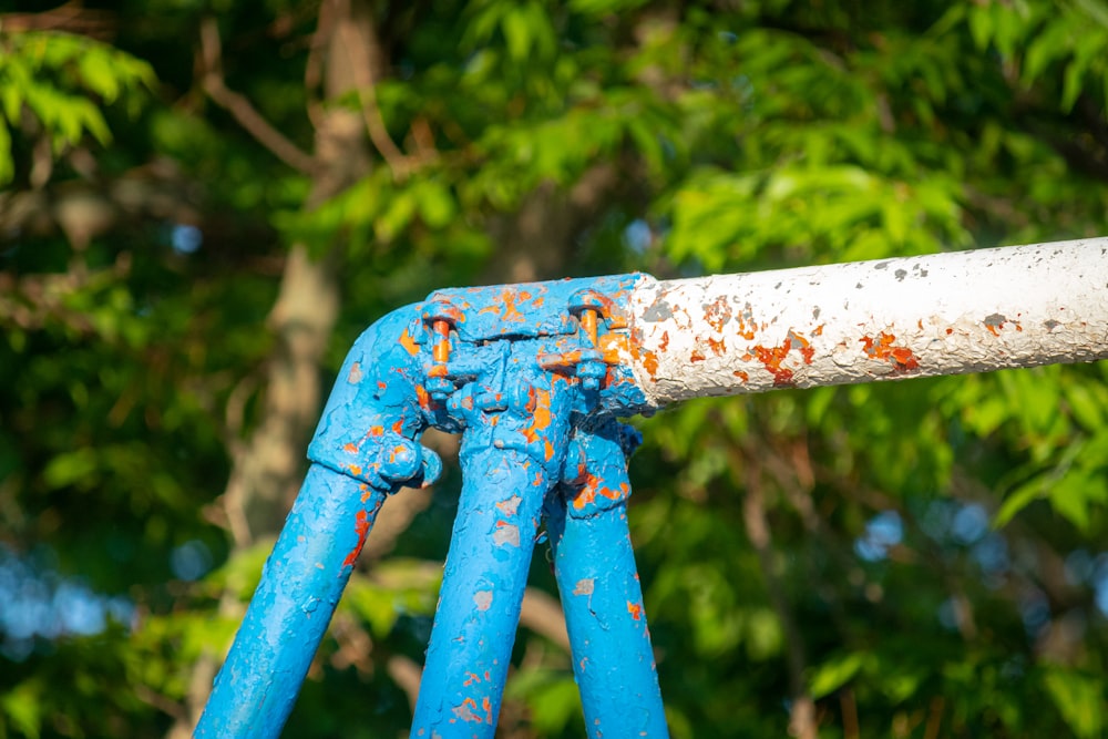 white and blue metal rod