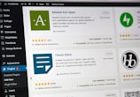 A computer screen displaying the WordPress dashboard with the Plugins section open. It shows various plugins such as Akismet Anti-Spam and Classic Editor with details like active installations, ratings, and update information. The left sidebar contains navigation options like Media, Comments, and Appearance.