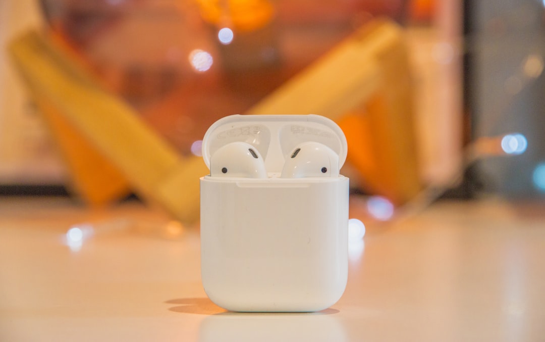 white Apple AirPods,