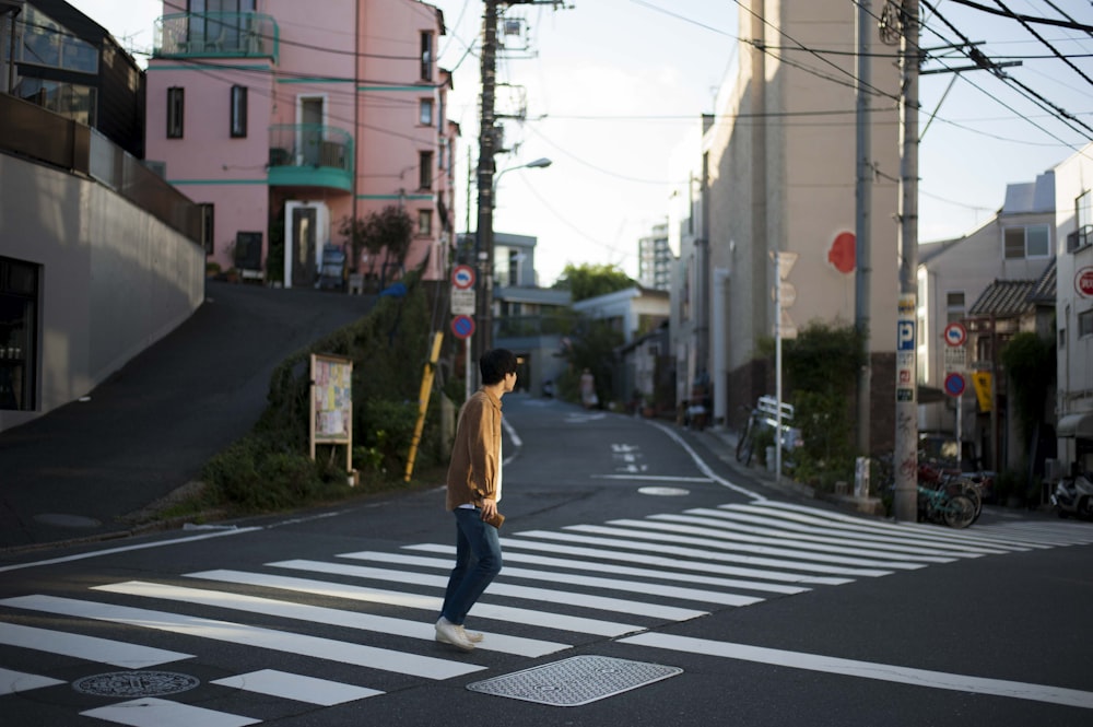 person crossing pedestrian lane during daytime