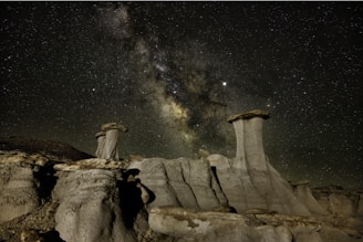 A breathtaking night sky filled with stars over the ancient ruins of Chaco Canyon, highlighting the mysterious beauty of the site.
