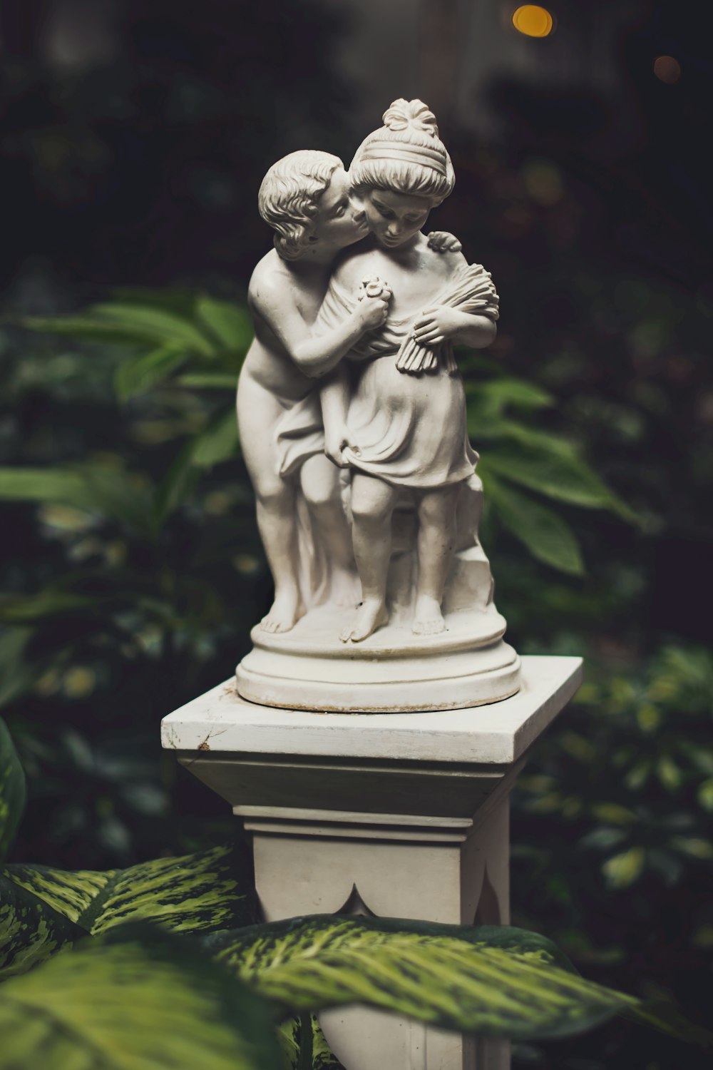 boy kissing girl statuette