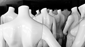 An array of uniforms displayed on mannequins in a bright studio.