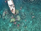 people swimming near boat