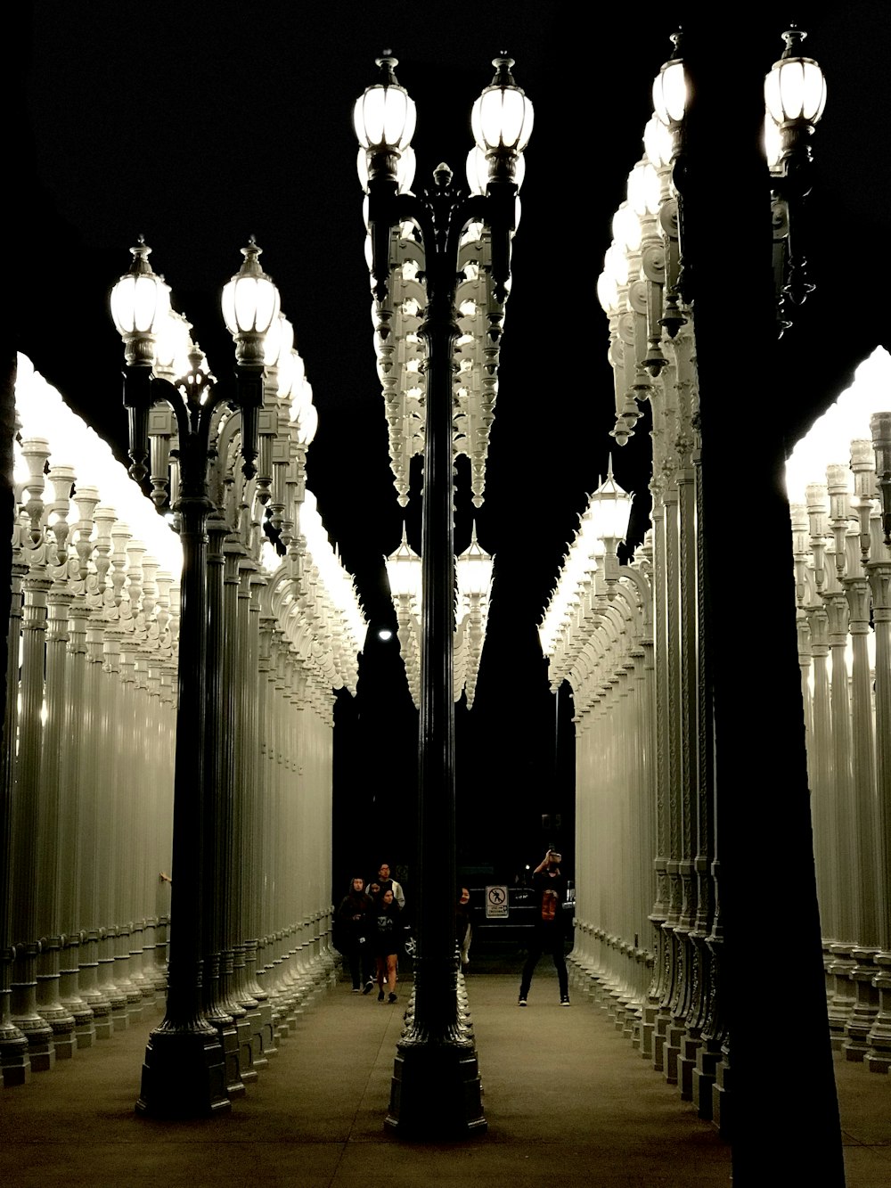 people walking near lighted posts