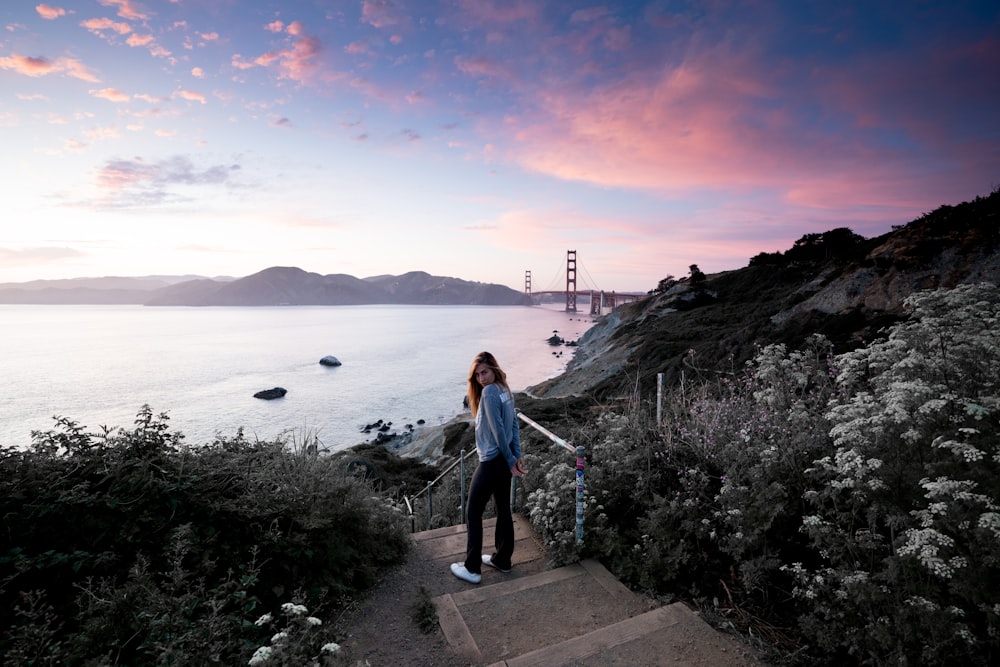 woman standing near body of water during daytime