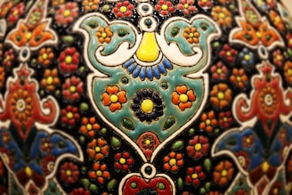 Close-up of a vibrant fileteado artwork with intricate floral patterns and bold lines.